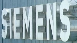 Siemens reports profits, cuts jobs