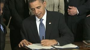 Obama signs landmark health bill into law