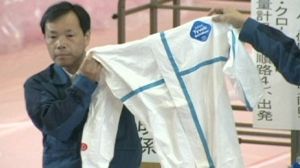 Japanese evacuees escorted home