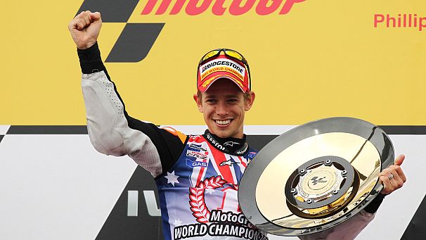 Stoner seals MotoGP title with home win