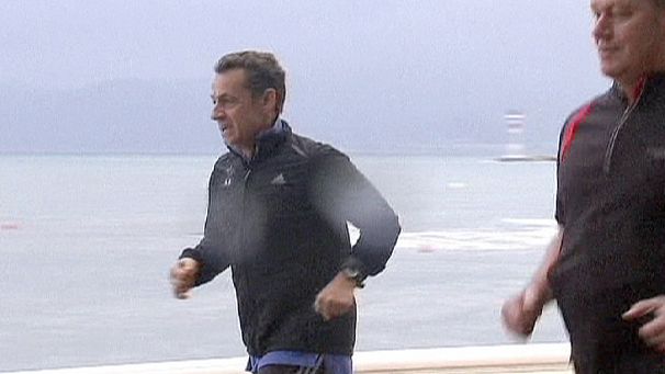 Sarkozy jogs in the rain as clouds gather over Europe