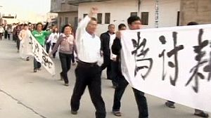 Chinese troops surround protesting village