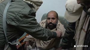 Gaddafi handover delayed in spat over money