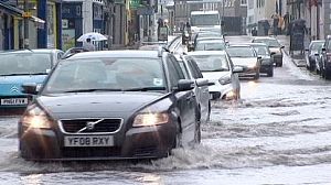 UK floods: Transport delays and power cuts continue