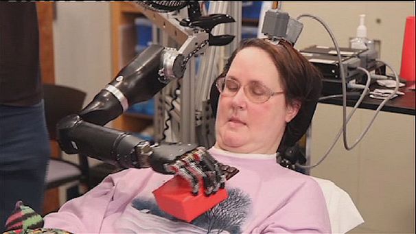 Paralysed woman feeds herself with robotic arm