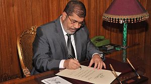 Egypt’s Mursi calls for unity as Islamist constitution becomes law
