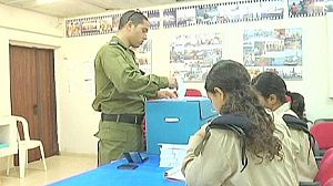 Israeli soldiers cast an early ballot