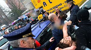 Topless women protest against Berlusconi as he votes in election – Video