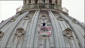 Anti-euro protester atop St. Peter's in Rome