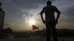 Turkish protesters await the return of defiant premier