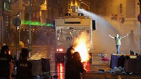 Riot police fire tear gas and a water cannon at Taksim Square