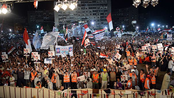 Pro-Mursi supporters wait on police to end their protests