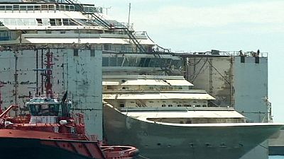 Costa Concordia wreck docks in Genoa Costa Concordia wreck docks in Genoa