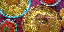 Enjoying a traditional Uzbek dish called plov