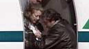 Injured hostage arrives back in Italy