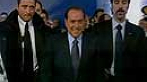 Bruised Berlusconi bites back