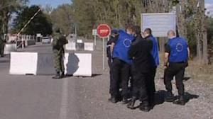 EU monitors watch checkpoint being dismantled