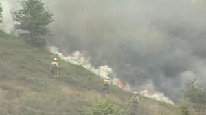 Winds fan flames in Spanish wildfires