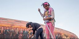 An 8-year-old and her friend sweep the pavement in La Paz.