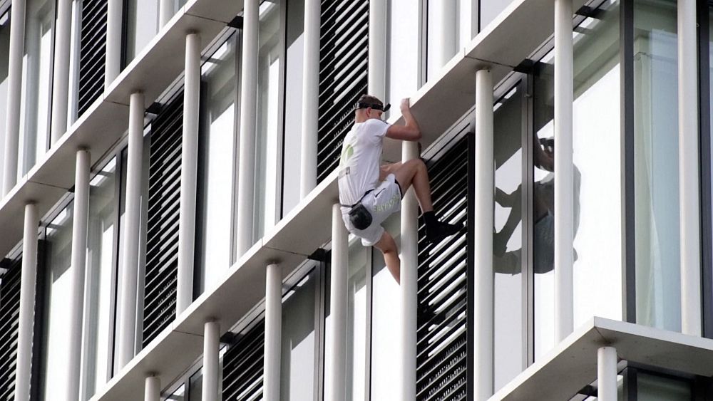 Free climber scales London skyscraper in climate stunt - NewsOpener Free climber scales London skyscraper in climate stunt
