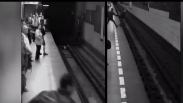 A woman 'walks off' after falling under train - Video A woman 'walks off' after falling under train - Video
