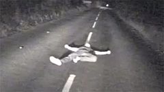 Watch: Drunk man seconds from death after lying down in middle of British road