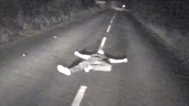 Watch: Drunk man seconds from death after lying down in middle of British road Watch: Drunk man seconds from death after lying down in middle of British road