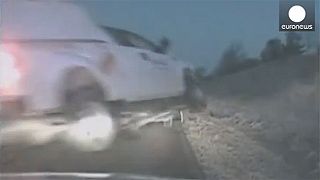 Watch: Crashing pick-up truck flies threw air just missing police officer