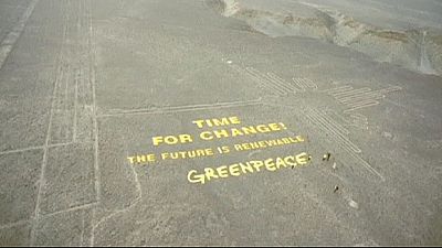 Giant Greenpeace banner beside ancient Nazca Lines