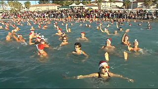 Christmas swimmers take a chilly dip in the Mediterranean