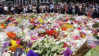 Flags fly at half-mast across Sydney after the violent end to a cafe siege