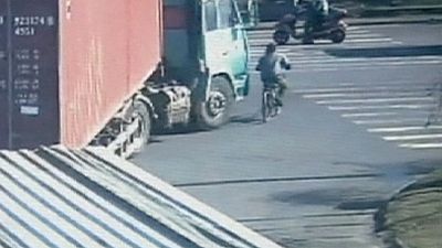 Cyclist's incredible escape after being run over by a lorry