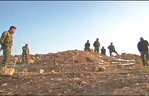 Yazidi return home to find mass graves