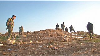 Yazidi return home to find mass graves