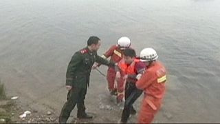 China: Driver rescued after driving car into river