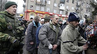 Captured Ukraine troops forced to face angry crowd after Donetsk bus stop shelling