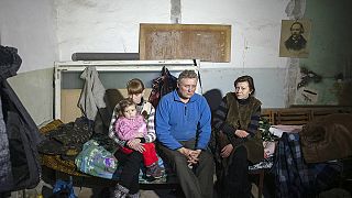 Ukraine's parliament argues about ceasefires as more refugees arrive from the east