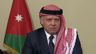 King Abdullah says killing will unite Jordanians but faces protests at home