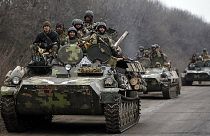 Ukraine begins heavy weapons withdrawal as bombardment eases