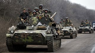 Ukraine begins heavy weapons withdrawal as bombardment eases