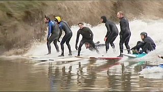 Surfers enjoy rare river wave