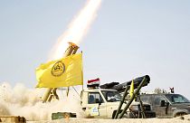 Iraqi soldiers and Shi'ite militia celebrate victory in Tikrit