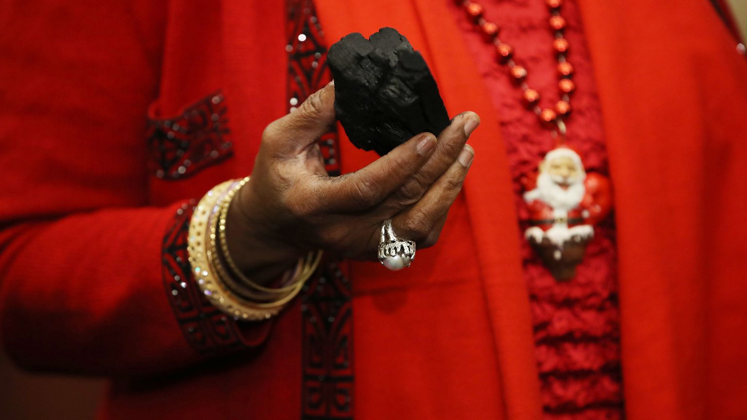 Image: Rep. Kathy Castor holds up a symbolic piece of coal
