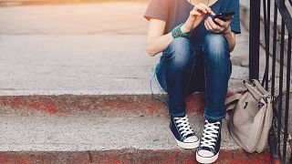 Image: Girl looking on phone