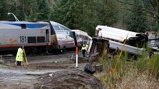 Image: Investigators begin analysis at the scene where an Amtrak passenger 