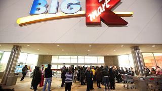 Image: Shoppers wait outside a Kmart in Griffith