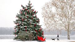 Image: A man walks a dog in St. Charles, Mo.