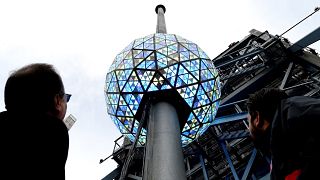 Image: Workers test out the lighting on the New Year's Eve ball