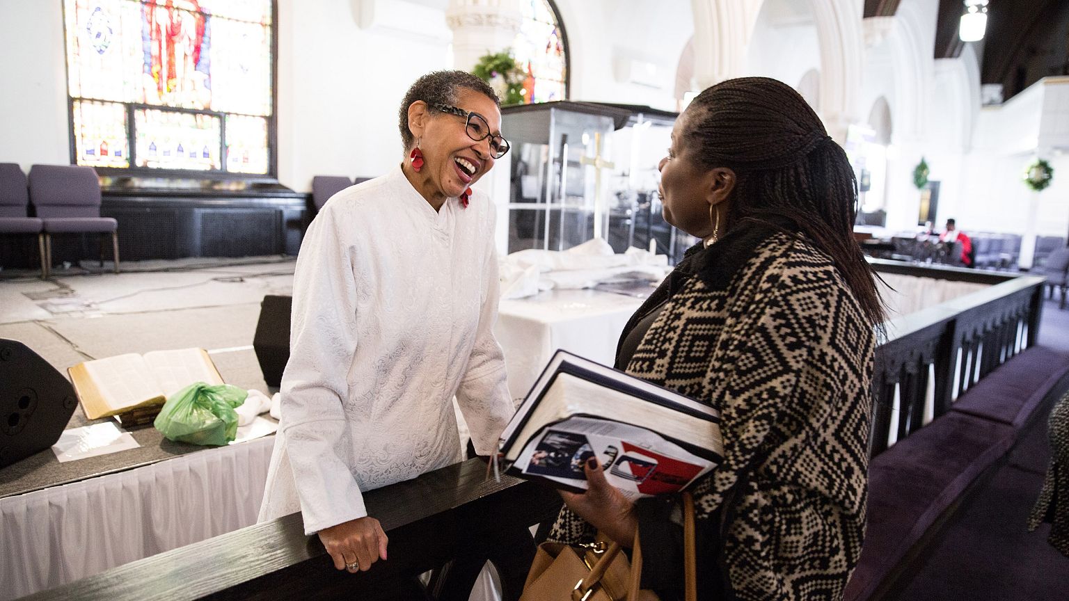 Image: Pastor Gloria White-Hammond speaks with parishioner Joyce Sackey Ach