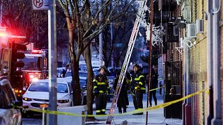Image: Fire Department of New York (FDNY) personnel work on the scene of an